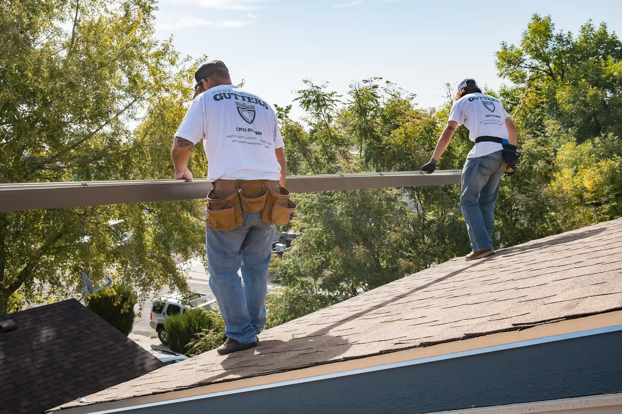 Fort Comfort Gutters crew installing seamless gutters on a Colorado home