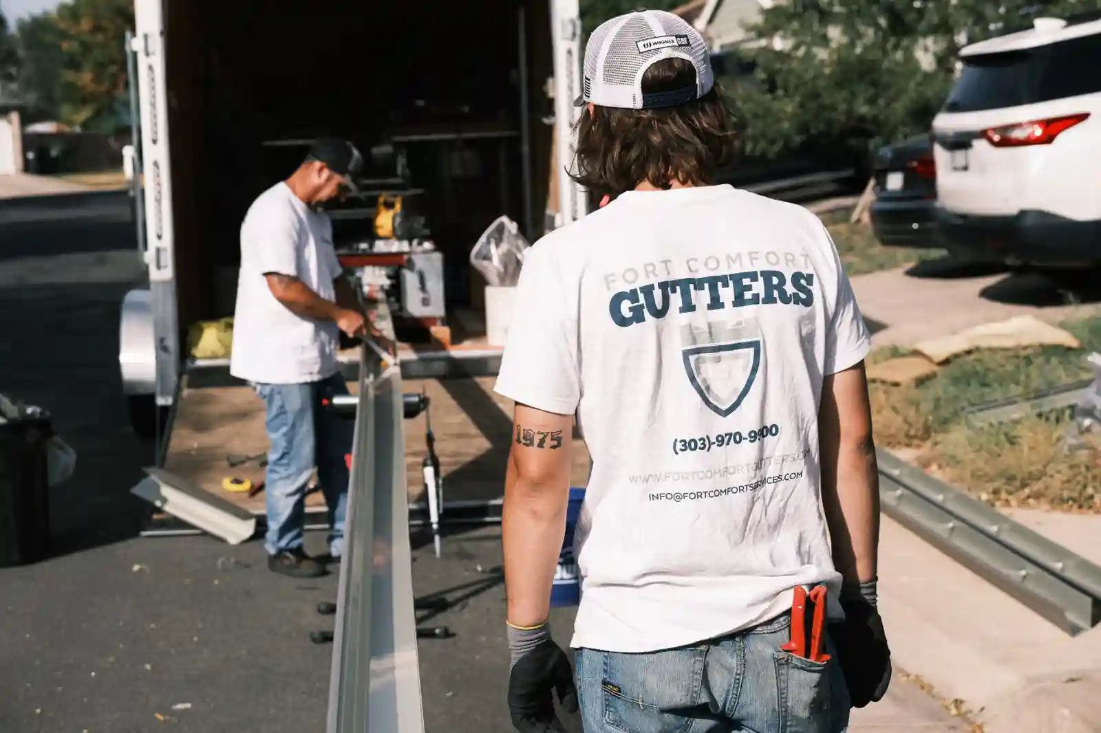 Fort Comfort Gutters crew installing seamless gutters on a Colorado home